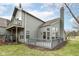 Home with backyard featuring a deck/patio, mature landscaping and gray siding at 7160 Harbour, Indianapolis, IN 46240