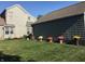 Backyard with potted flowers and a lush green lawn at 7160 Harbour, Indianapolis, IN 46240