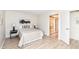 Clean bedroom with hardwood floors, black bedside tables, closet with sliding doors and ensuite bathroom at 7160 Harbour, Indianapolis, IN 46240