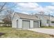 Attached two car garage with neutral gray siding, and a driveway at 7160 Harbour, Indianapolis, IN 46240