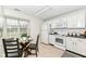 Bright eat-in kitchen features white appliances, light countertops, and a window for natural light at 7160 Harbour, Indianapolis, IN 46240
