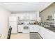 Bright kitchen features white appliances and cabinets and dark countertops at 7160 Harbour, Indianapolis, IN 46240
