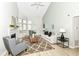A cozy living room with a fireplace, high ceilings, and natural light creates an inviting atmosphere at 7160 Harbour, Indianapolis, IN 46240