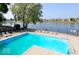 Community pool with lounge chairs overlooking a serene lake, perfect for relaxation and recreation at 7160 Harbour, Indianapolis, IN 46240