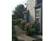 Landscaped side yard with a variety of flowers and plants, adding to the home's curb appeal at 7160 Harbour, Indianapolis, IN 46240