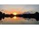 Sunset view over a calm lake with trees silhouettes in the background at 7160 Harbour, Indianapolis, IN 46240