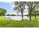 Backyard waterfront with trees, green grass, boats, and open views at 7160 Harbour, Indianapolis, IN 46240
