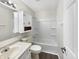 Well-lit bathroom with a combined bathtub and shower and vanity storage space at 7228 Muirfield Pl, Indianapolis, IN 46237