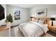 Comfortable bedroom with large window, side tables, lamps, and a neutral color scheme at 7228 Muirfield Pl, Indianapolis, IN 46237