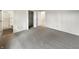 Spacious bedroom featuring plush gray carpet and a glimpse into the adjoining bathroom at 7228 Muirfield Pl, Indianapolis, IN 46237