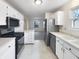 Updated kitchen with stainless steel appliances, white cabinets, and tile flooring at 7228 Muirfield Pl, Indianapolis, IN 46237