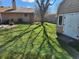 Backyard featuring a shed and mature trees casting shadows on the well-maintained lawn at , Indianapolis, IN 46217