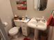 Charming powder room with pedestal sink, vintage mirror, and decorative accents for a quaint feel at , Indianapolis, IN 46217