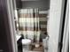 Charming bathroom featuring stylish fixtures, neutral-colored shower curtain, and bright lighting at , Indianapolis, IN 46217