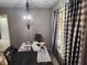 Cozy dining area is filled with a chandelier and a window with beautiful curtains at , Indianapolis, IN 46217