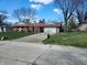 Traditional single-story brick home with an attached garage and a neatly manicured lawn at , Indianapolis, IN 46217