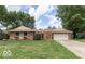Charming brick home with an attached garage and a well-maintained front lawn at , Indianapolis, IN 46217