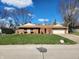 Traditional single-story brick home with a neatly manicured lawn and mature trees at , Indianapolis, IN 46217