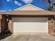 Spacious attached garage with a classic panel door and exterior lighting fixtures at , Indianapolis, IN 46217