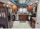 Well-equipped kitchen with stainless steel refrigerator, ample cabinetry, and tiled floors at , Indianapolis, IN 46217