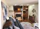 Comfortable living room boasts a fireplace with TV, hardwood floors, and decorative built-in shelves at , Indianapolis, IN 46217