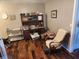 Office space with warm hardwood floors, an armchair, and abundant shelving for optimal organization at , Indianapolis, IN 46217