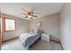 Bedroom featuring a single bed, white nightstands, ceiling fan and a large window at 802 Burwick Trce, Greenwood, IN 46143