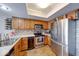 Modern kitchen with stainless appliances, granite countertops, backsplash, and ample storage at 802 Burwick Trce, Greenwood, IN 46143
