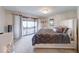 Main bedroom with sliding glass door to a balcony, with a decorative bed and dresser at 802 Burwick Trce, Greenwood, IN 46143