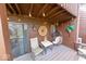 Relaxing covered patio with hanging chair and charming decor at 802 Burwick Trce, Greenwood, IN 46143