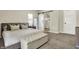Comfortable bedroom featuring a king-size bed and a sliding barn door to the bathroom at 934 E Minnesota St, Indianapolis, IN 46203