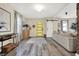 Bright entryway features modern decor, stylish furniture, and a statement yellow door enhancing the welcoming ambiance at 934 E Minnesota St, Indianapolis, IN 46203