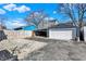 Detached garage with an attached carport and paved parking area at 934 E Minnesota St, Indianapolis, IN 46203