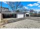 Ample parking space with multiple garages, featuring brick paving and driveway access at 934 E Minnesota St, Indianapolis, IN 46203