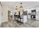 Kitchen with white cabinets, stainless steel appliances, island with seating, and modern decor at 934 E Minnesota St, Indianapolis, IN 46203