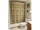 Well-maintained bathroom featuring a decorative shower curtain and functional shelving at 12652 Meeting House Rd, Carmel, IN 46032