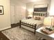 Cozy bedroom featuring a wrought iron bed frame and soothing neutral tones at 12652 Meeting House Rd, Carmel, IN 46032