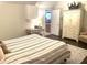 Comfortable bedroom with hardwood floors, dresser, and a view into another room at 12652 Meeting House Rd, Carmel, IN 46032