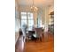 Dining room with natural light, hardwood floors, and stylish chandelier at 12652 Meeting House Rd, Carmel, IN 46032