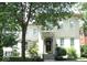 Charming two-story home with brick facade, landscaped yard, and mature trees providing shade at 12652 Meeting House Rd, Carmel, IN 46032