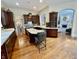 Open kitchen with island, dark wood cabinetry, and view to living area at 12652 Meeting House Rd, Carmel, IN 46032