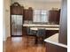 Well-lit kitchen featuring stainless steel fridge and dark wood cabinets at 12652 Meeting House Rd, Carmel, IN 46032