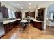 Spacious kitchen with dark wood cabinets, stainless steel appliances, and white countertops at 12652 Meeting House Rd, Carmel, IN 46032