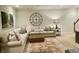 Cozy living room showcasing a large sectional sofa, patterned rug, and a decorative clock and art piece at 12652 Meeting House Rd, Carmel, IN 46032