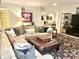 Comfortable living room with plush sectional sofa, leather ottoman, and stylish decor at 12652 Meeting House Rd, Carmel, IN 46032