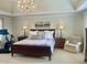 Bright main bedroom with tray ceiling, chandelier and large windows at 12652 Meeting House Rd, Carmel, IN 46032