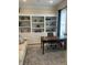 Bright office features built-in shelves, sofa, rug, and dark wood desk at 12652 Meeting House Rd, Carmel, IN 46032