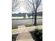 Community pond featuring a fountain with sidewalks and street in the foreground at 12652 Meeting House Rd, Carmel, IN 46032