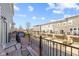 Balcony view overlooking a row of townhomes, with seating and a grill at 13783 Tender Dr, Carmel, IN 46032