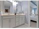 Bathroom featuring double sink vanity, grey cabinets, and an open doorway leading to the bedroom at 13783 Tender Dr, Carmel, IN 46032